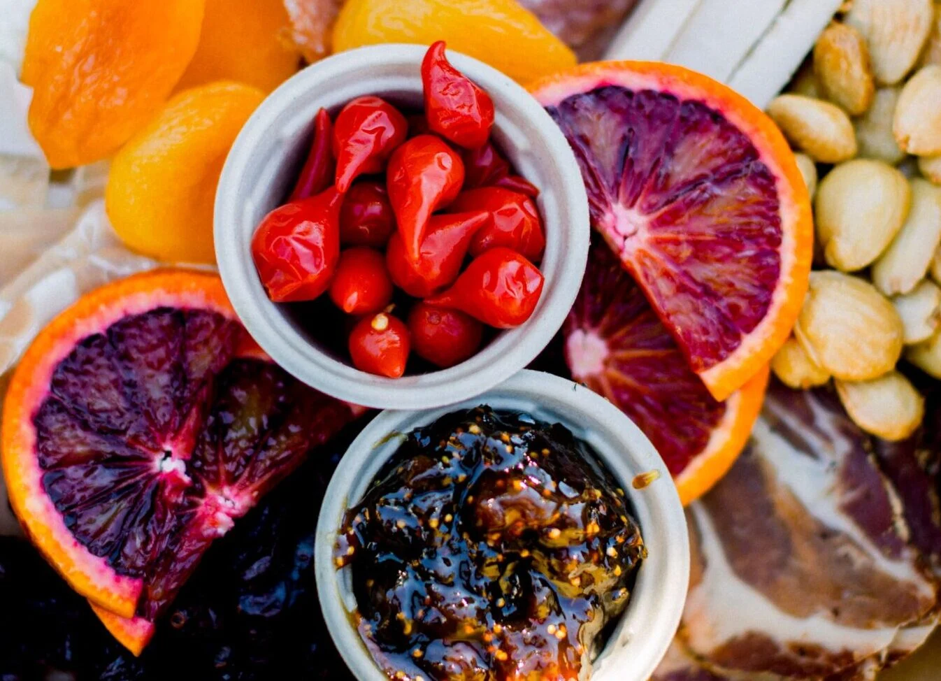 Close-up of charcuterie box with fig jam and blood orange