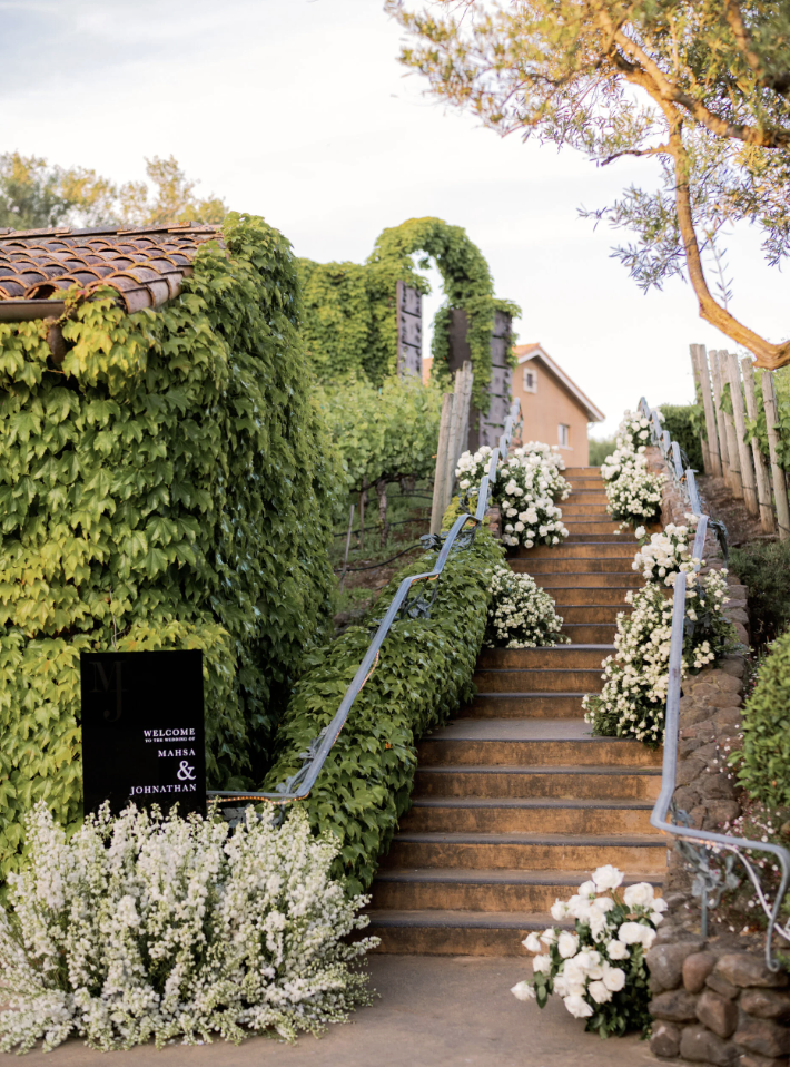 Floral-lined staircase leading up through the estate